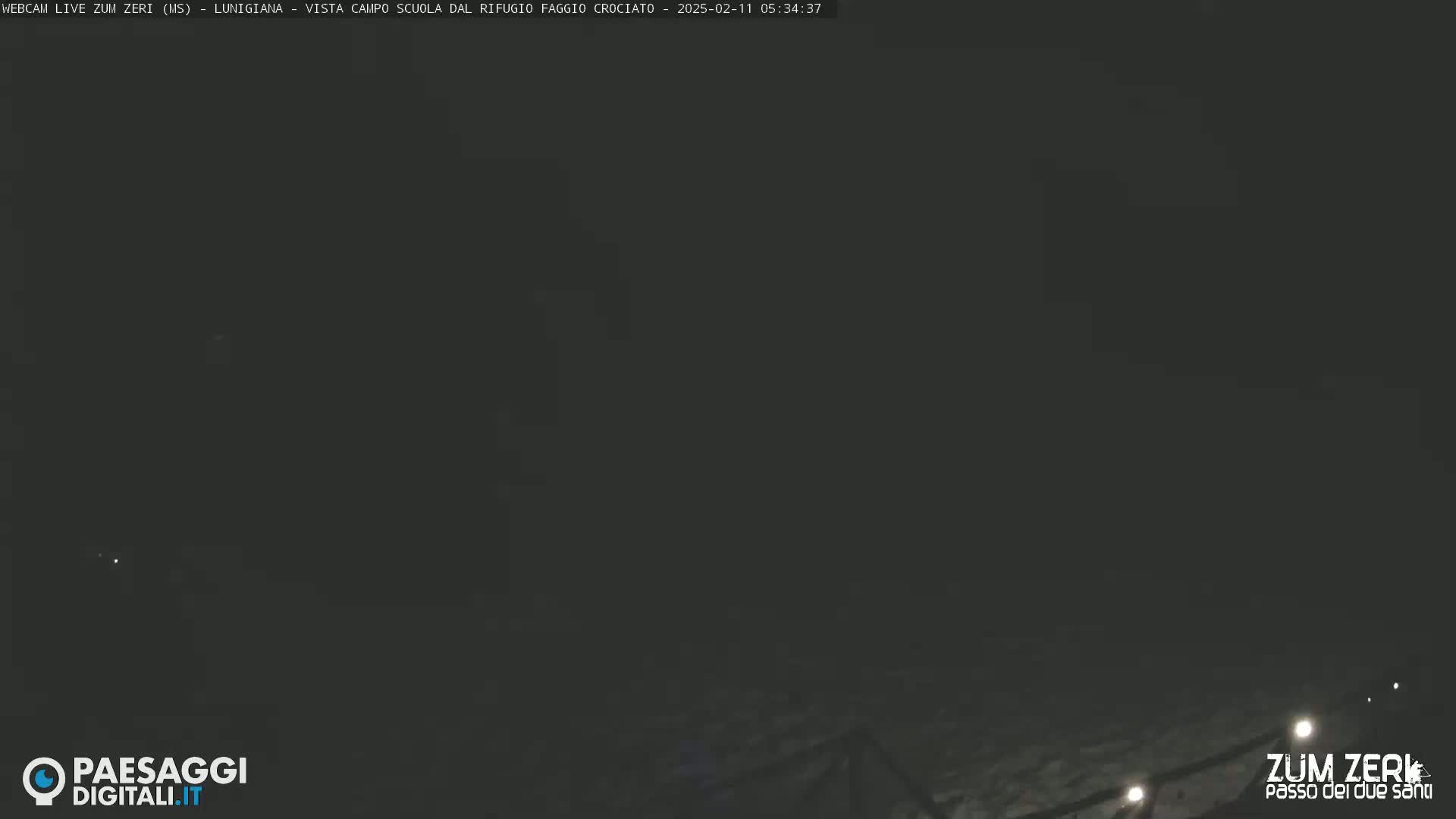 A dark, nighttime outdoor scene shows a dimly lit area with minimal visibility.
