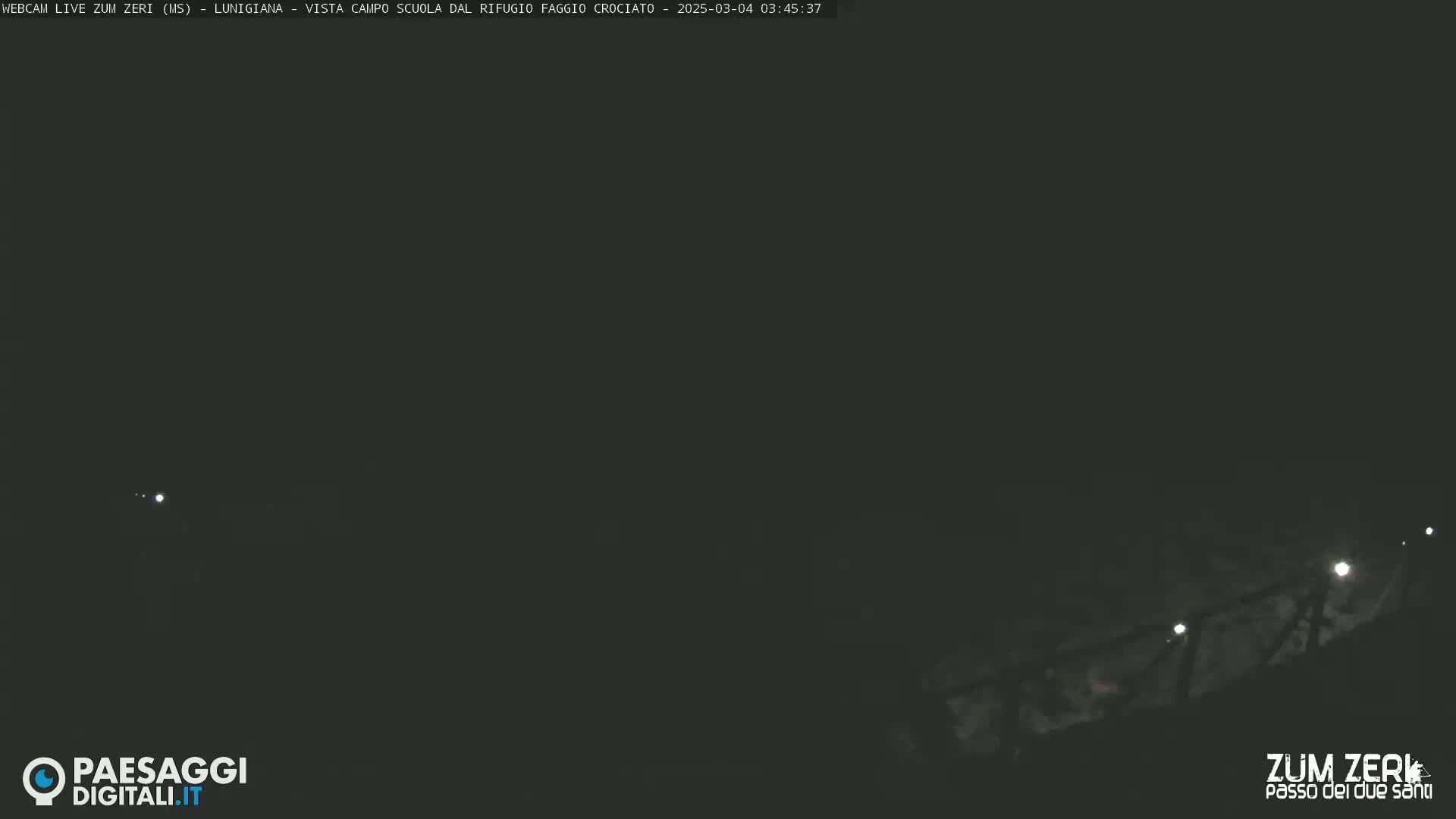 A dark, nighttime scene shows a dimly lit structure sloping down towards the bottom of the frame.