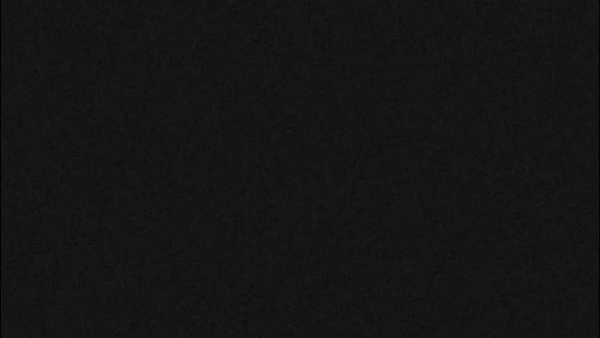 The image shows a dark gray or black textured surface.