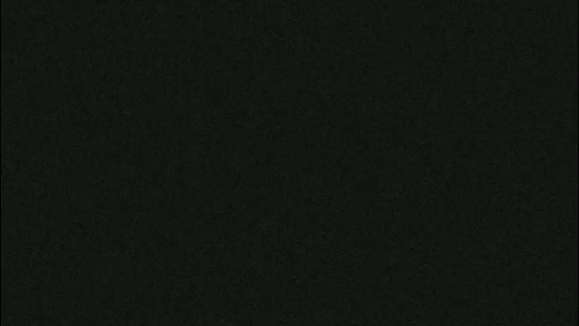 The image is a solid dark-greenish black background with a slightly textured surface.