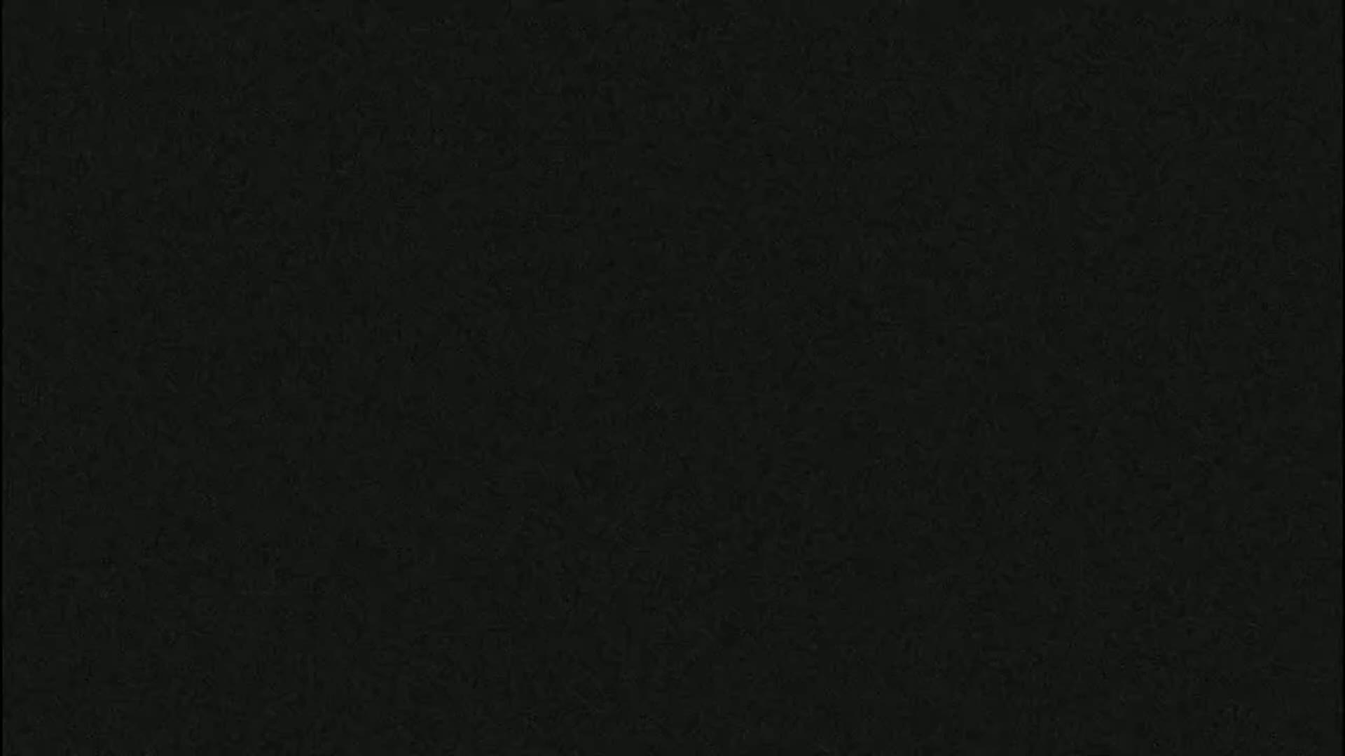 The image shows a dark gray textured surface.