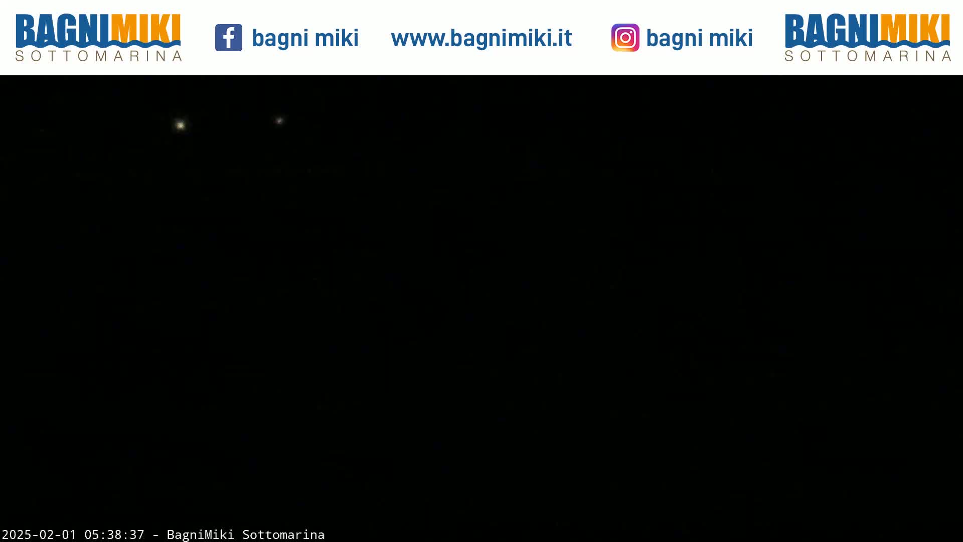 A nighttime, dark image shows two faint, distant lights in the sky.