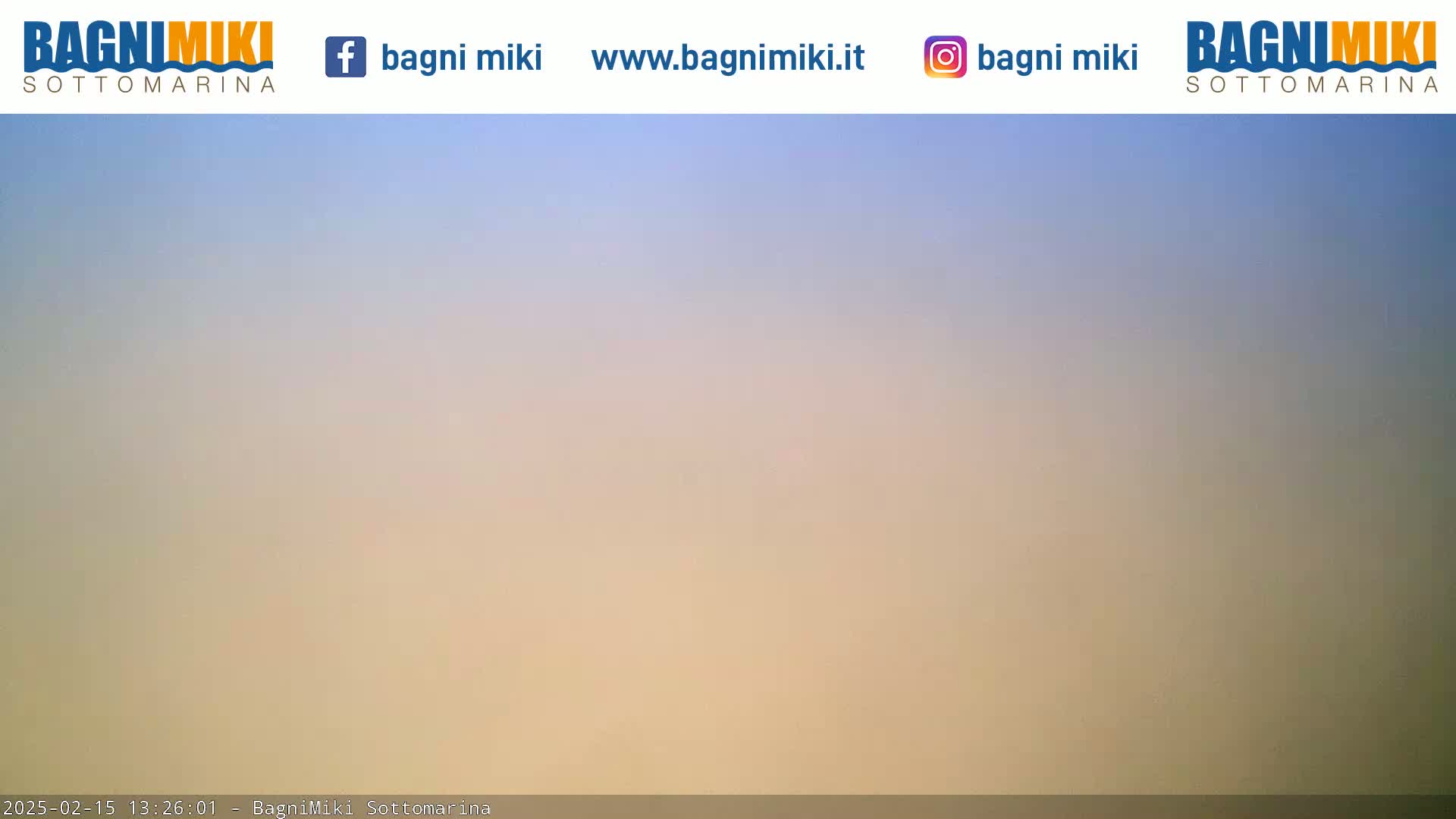 A hazy, pale-blue and beige sky is visible.