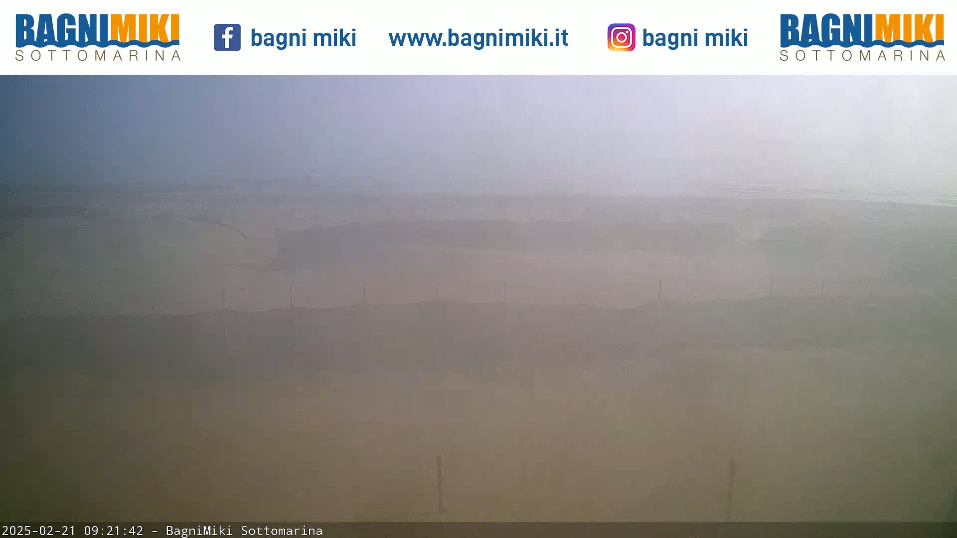 A hazy, overcast view of a flat landscape stretches to the horizon.