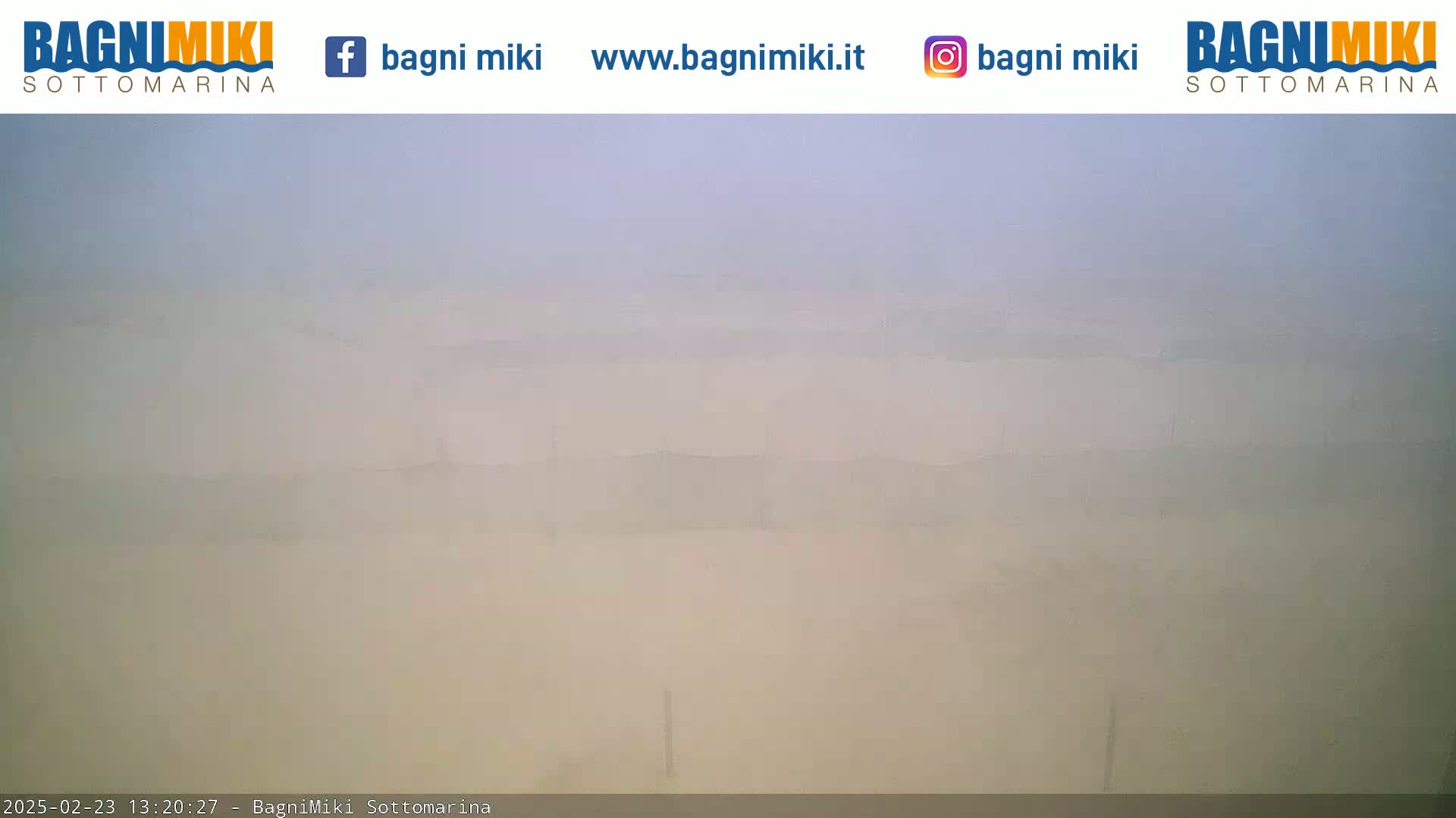 A hazy, light-colored landscape is visible in the distance, obscured by atmospheric conditions.