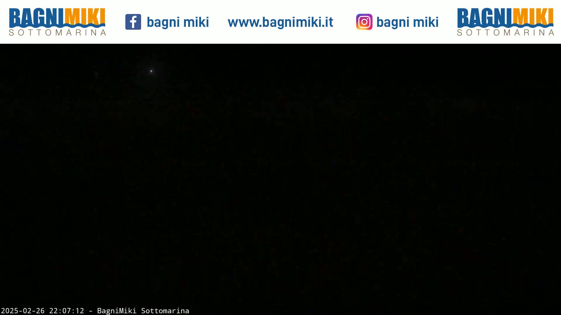 A nighttime scene shows a dark sky with a few faint lights visible.