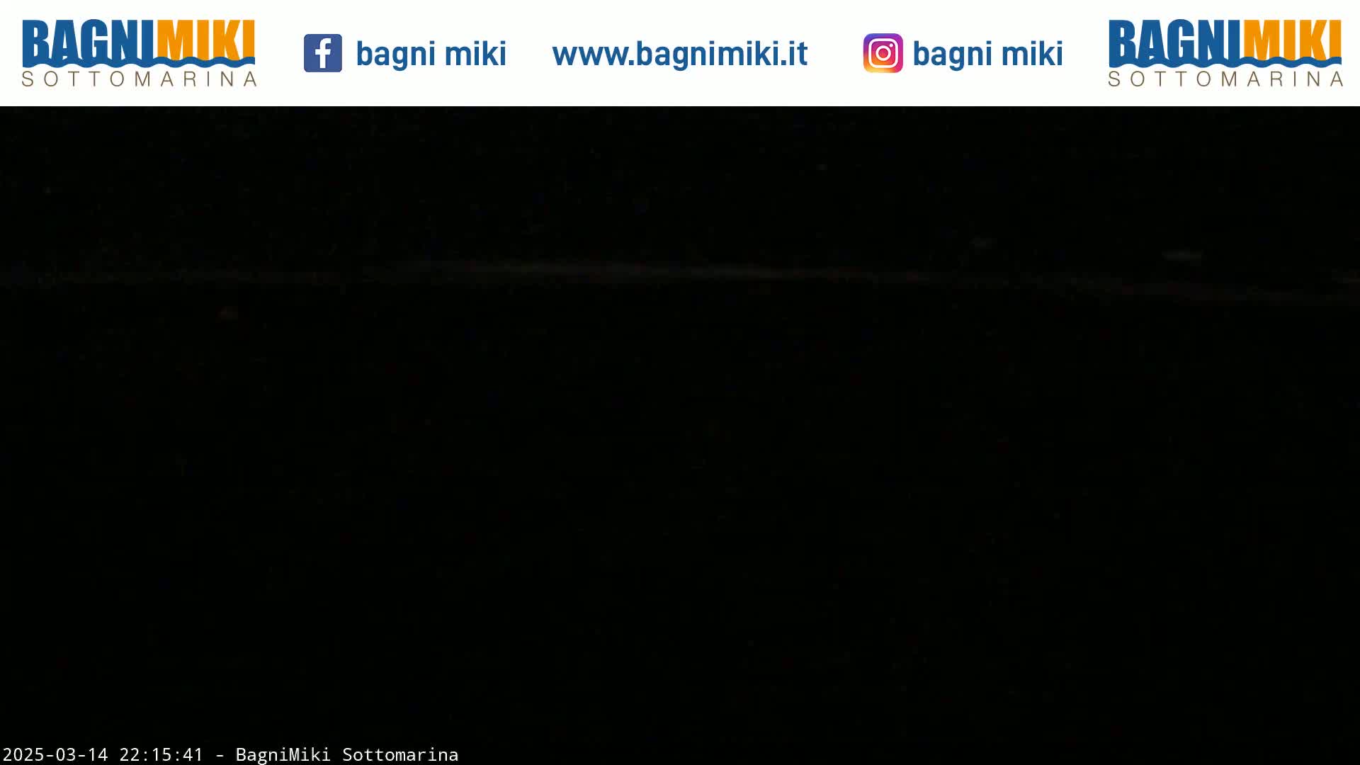 A mostly black image shows a very dark scene, possibly at night.