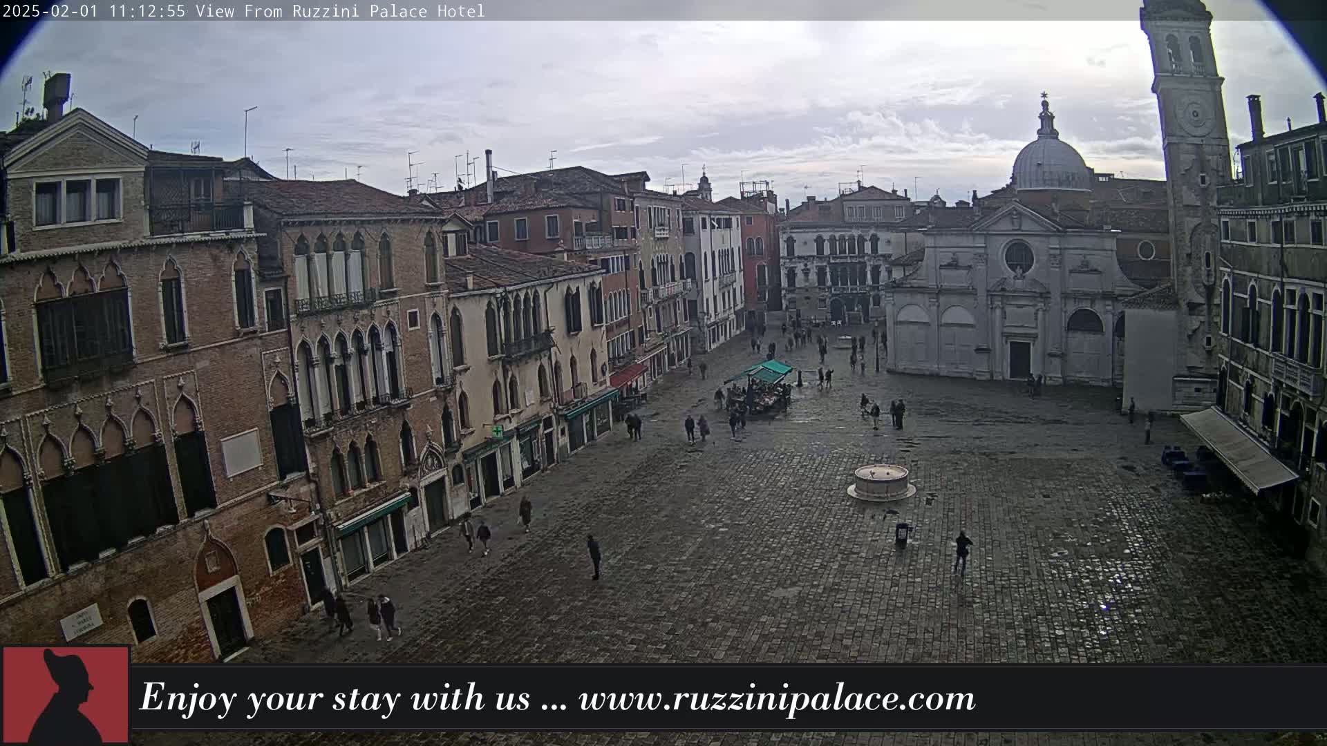 A cobblestone square in Venice, Italy, is sparsely populated under an overcast sky.