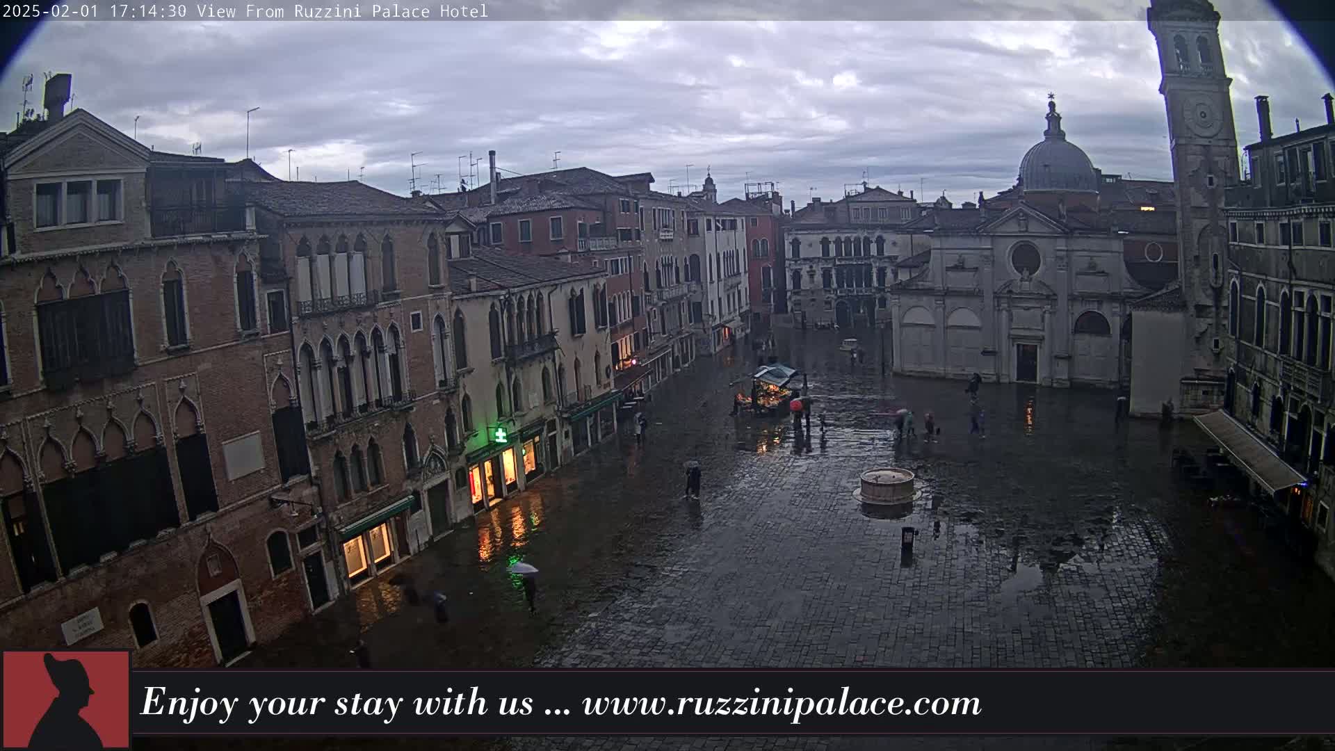 A rain-slicked Venetian square is surrounded by historic buildings under a cloudy sky.