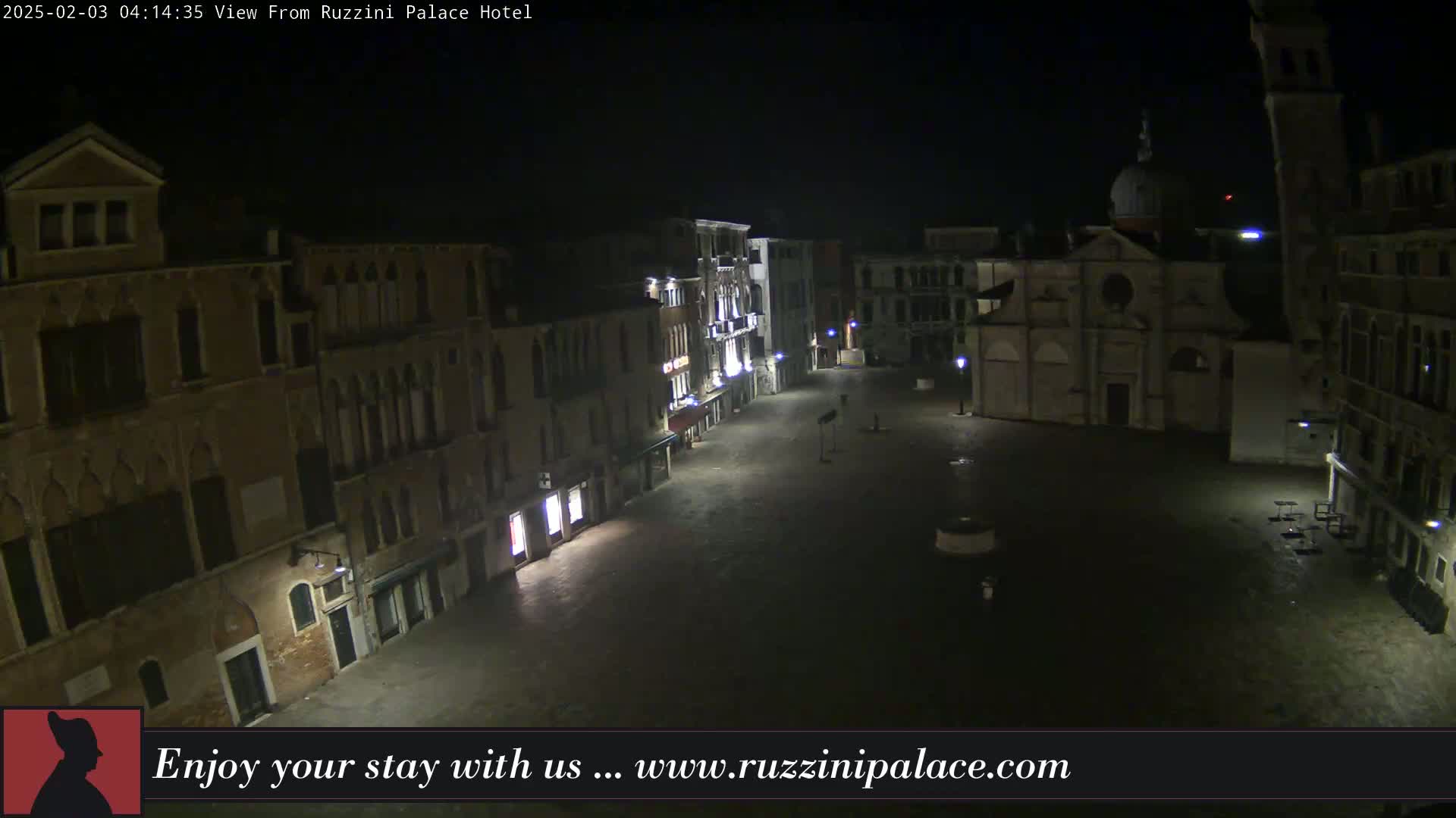 A nighttime, dimly lit, empty square in Venice, surrounded by old buildings.
