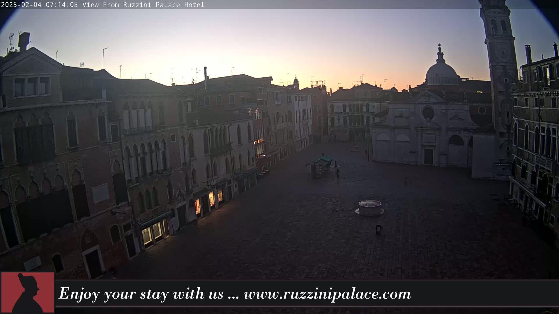 A mostly empty, sunlit Venetian square is surrounded by old buildings at dawn.