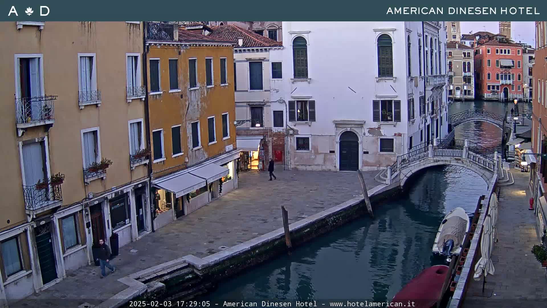A canal in Venice, Italy, with several buildings lining its banks under a twilight sky.