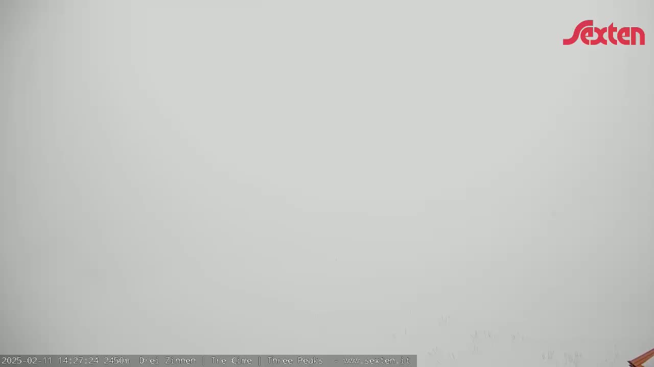 A solid, light-grey, featureless expanse is shown under foggy or overcast conditions.
