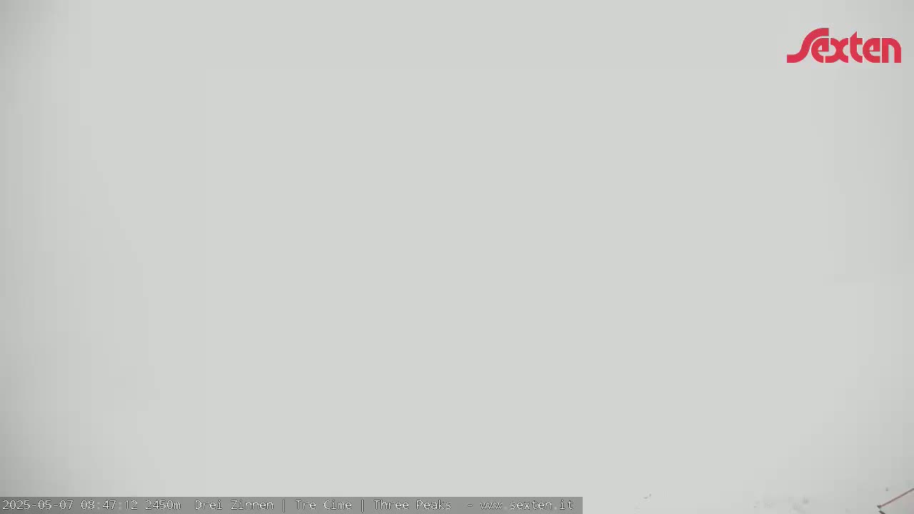 A solid, light-grey, overcast sky is visible.