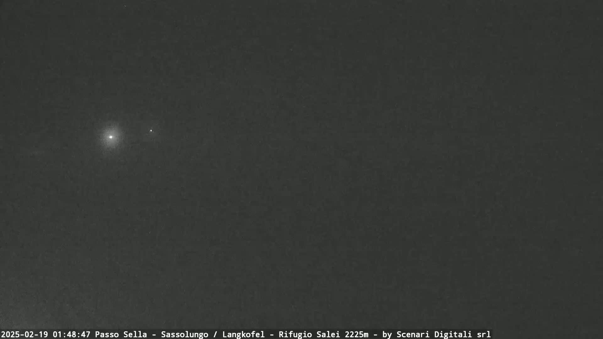 A dark night sky shows two bright celestial bodies, possibly planets or stars.