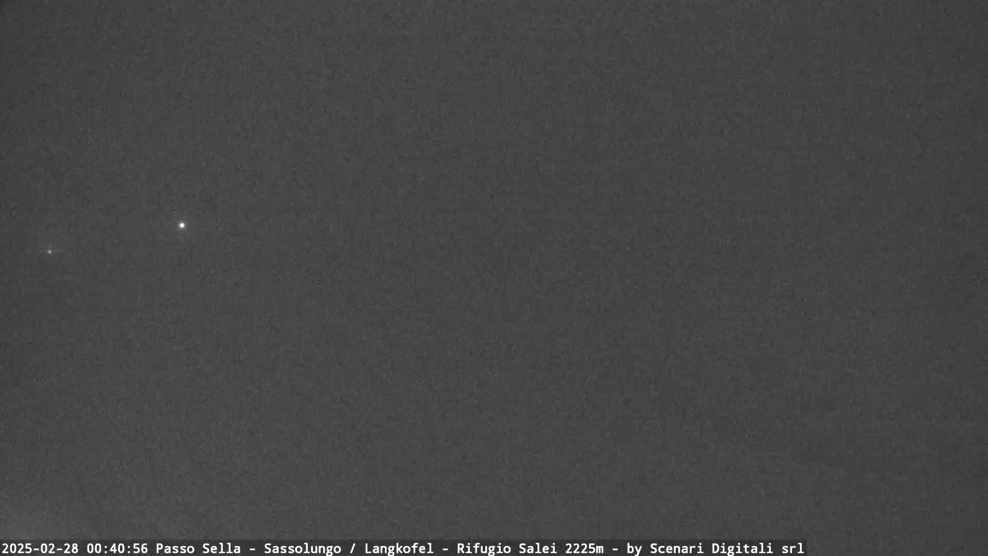A dark, night sky shows two faint points of light.
