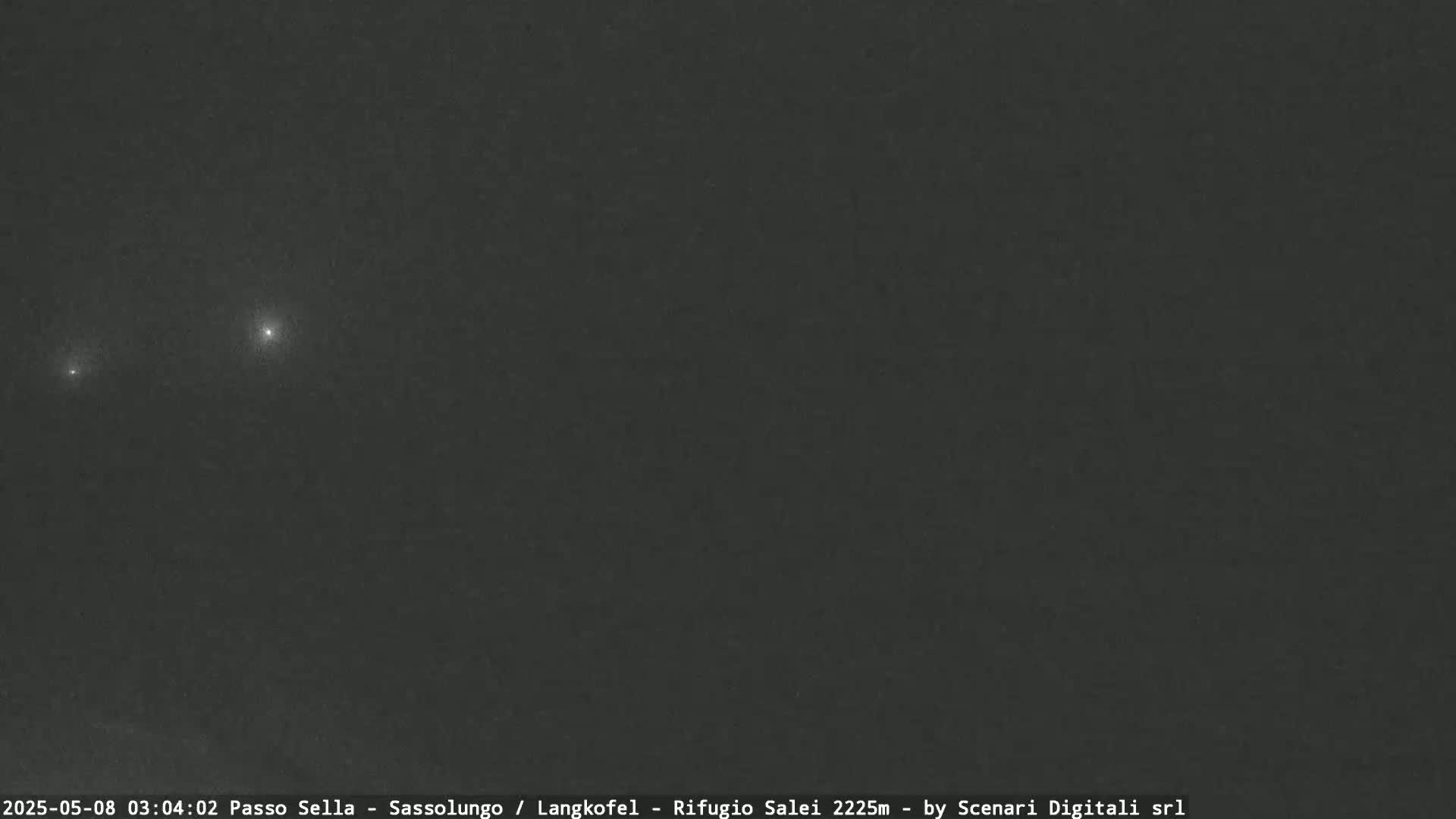 Three bright lights are visible in a dark, nighttime sky.