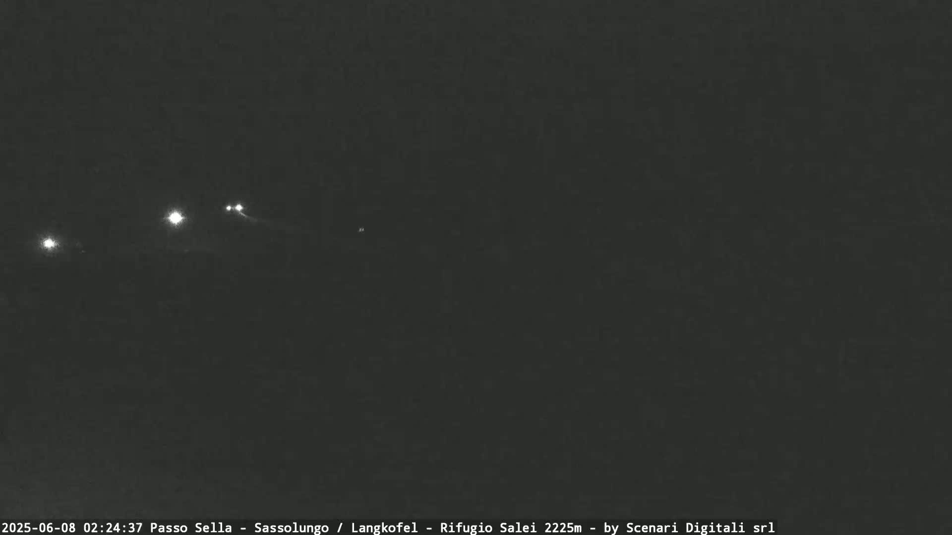 A nighttime, dark view of several distant lights.