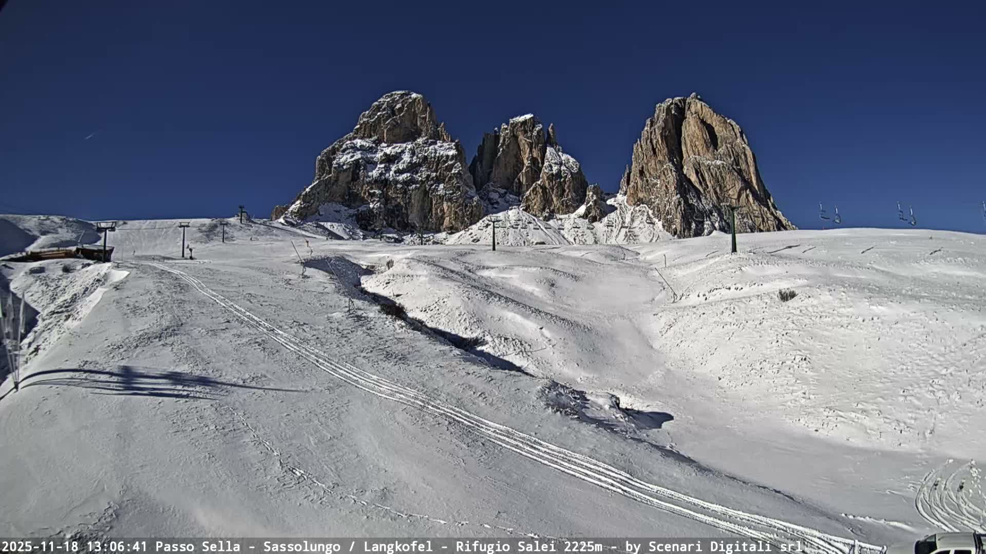 A very dark outdoor scene at night shows several diffused bright lights, likely from vehicles on a winding road, indicating low visibility due to fog or mist.