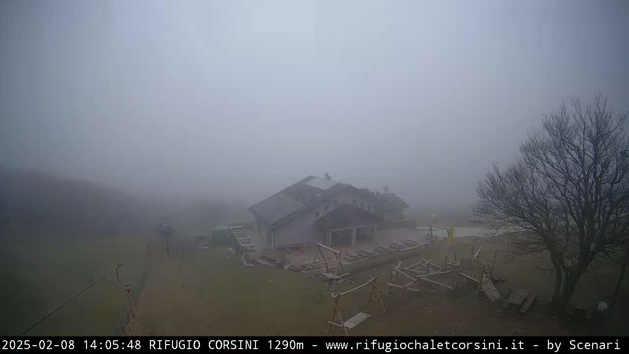 A building with a playground is visible in a foggy landscape.