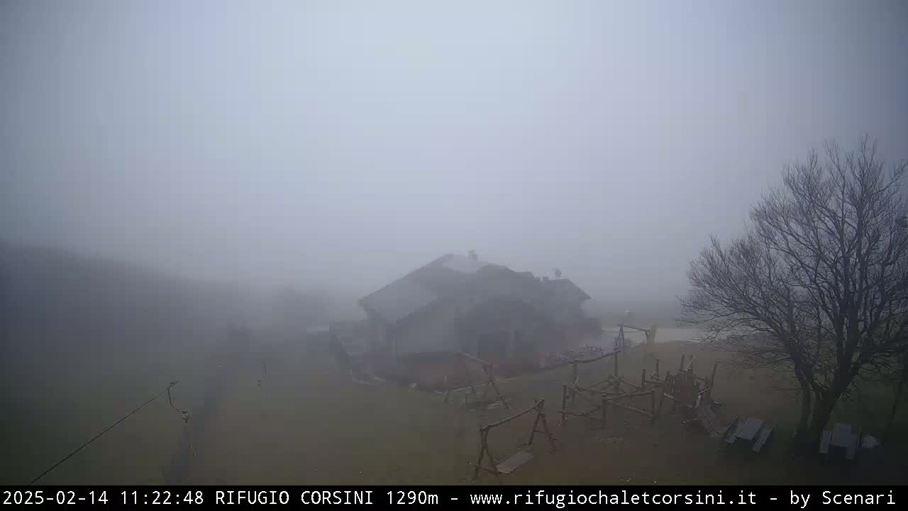 A house with a playground is shrouded in thick fog.