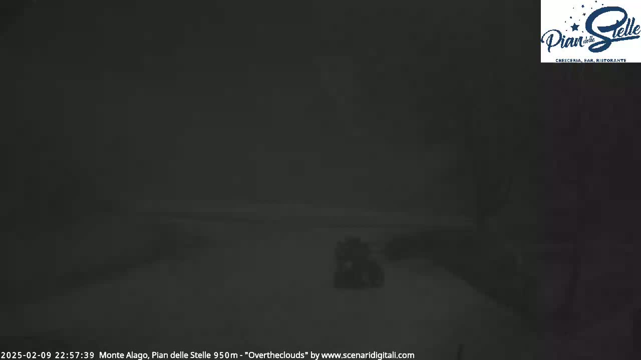A dark, snowy, nighttime scene is visible, showing a blurry, indistinct landscape.