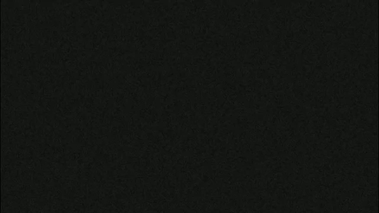 The image shows a dark gray or black textured surface.