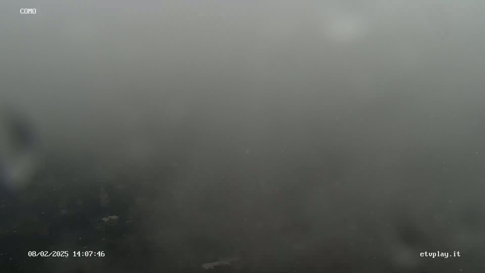 A very thick fog obscures the view of an outdoor scene.
