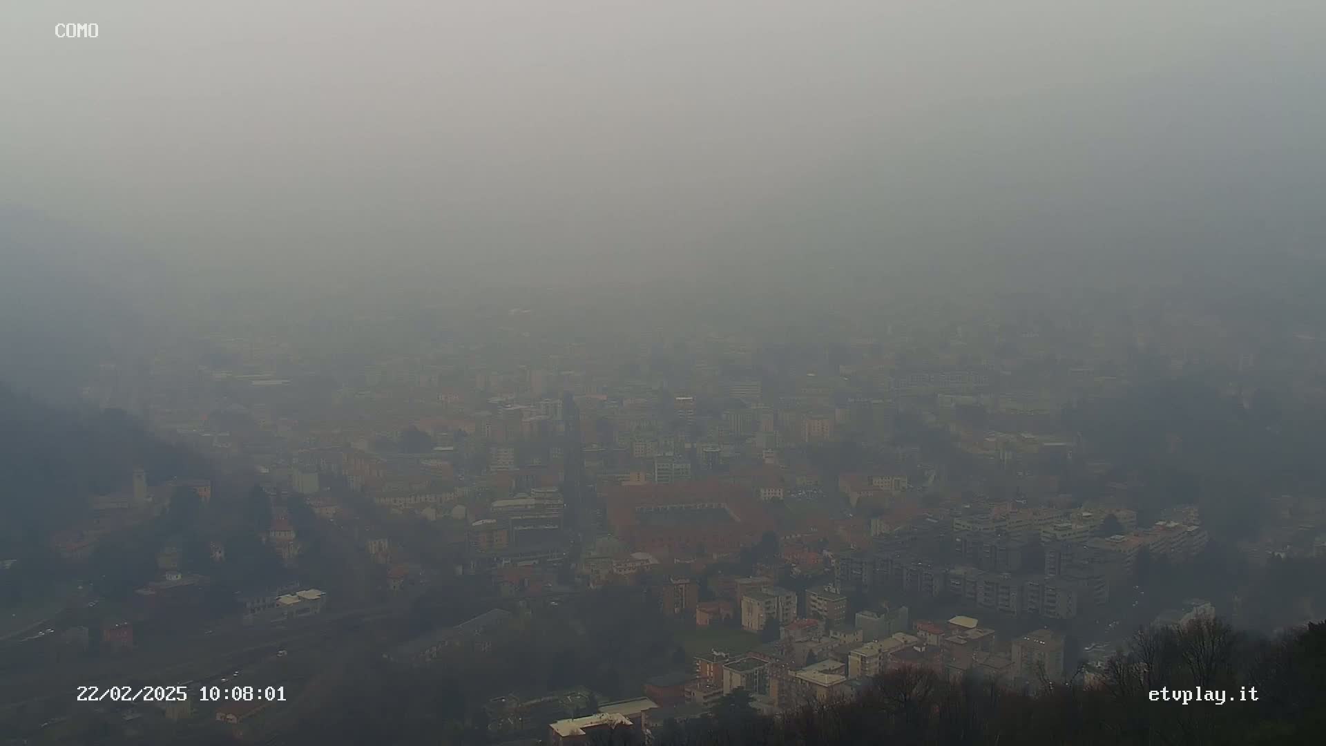 A hazy, distant view of a city shrouded in fog or smog.