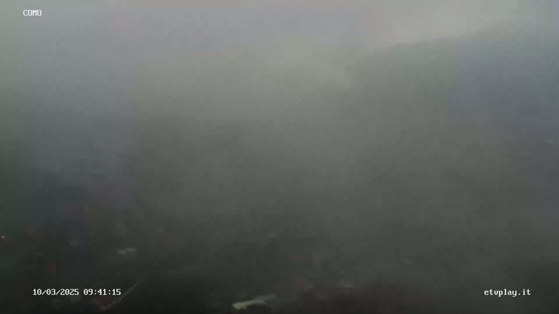 A very dense fog obscures the view of an outdoor scene.