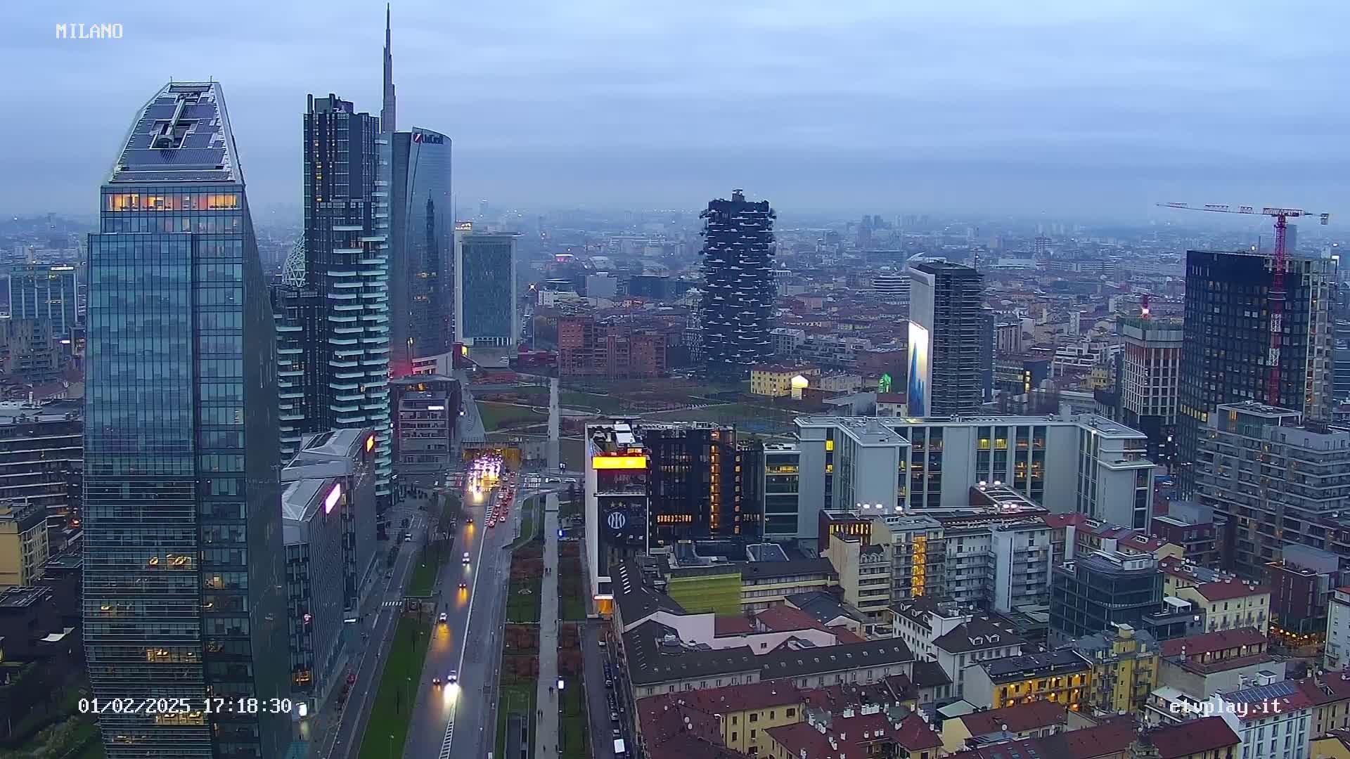 A cityscape of many tall buildings under an overcast sky.