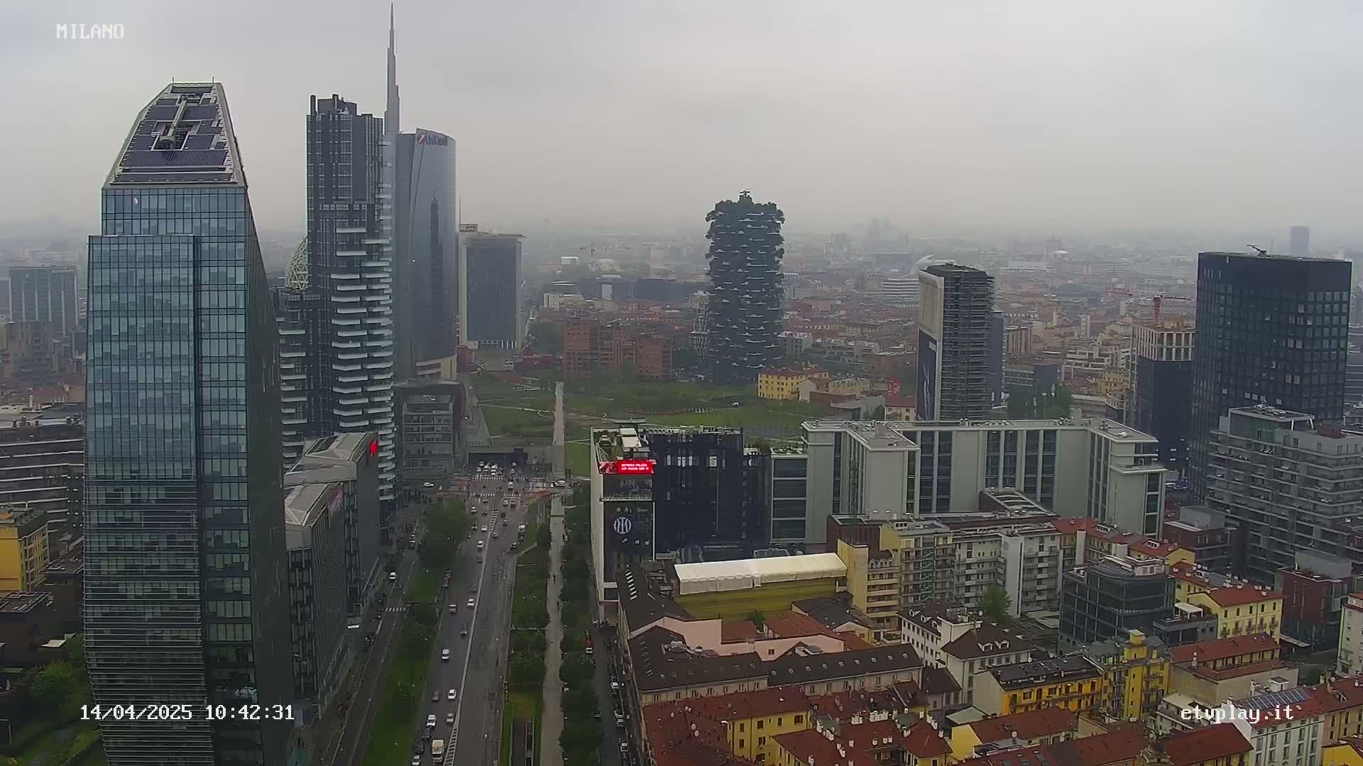 A cityscape of numerous skyscrapers and other buildings under an overcast sky.