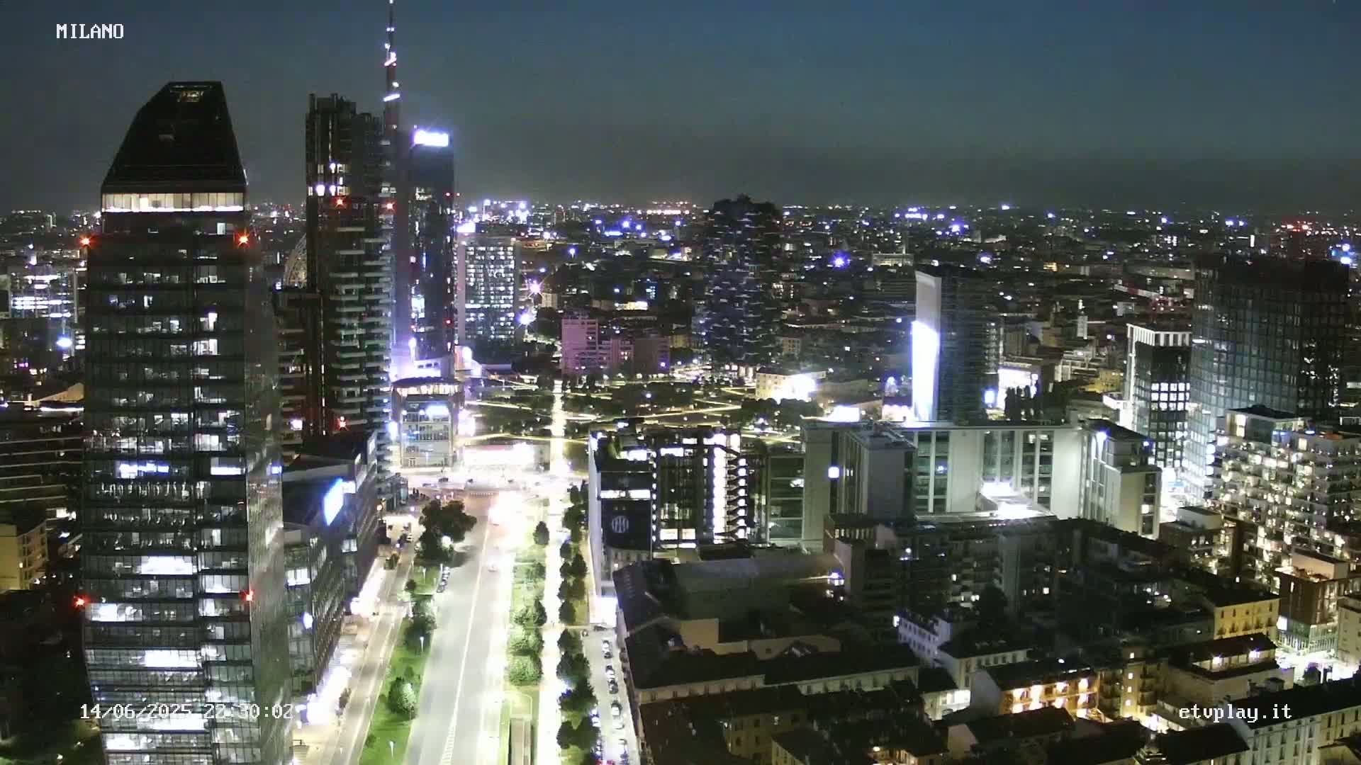 An aerial view shows a city skyline of numerous skyscrapers and high-rise buildings under hazy conditions.
