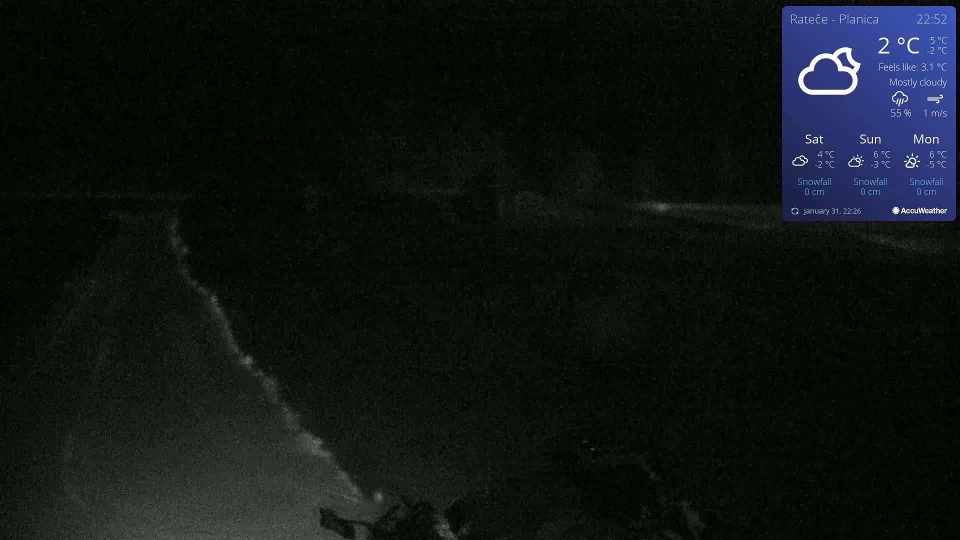 A mostly cloudy nighttime scene shows a dark, snow-covered landscape under a 2°C temperature.