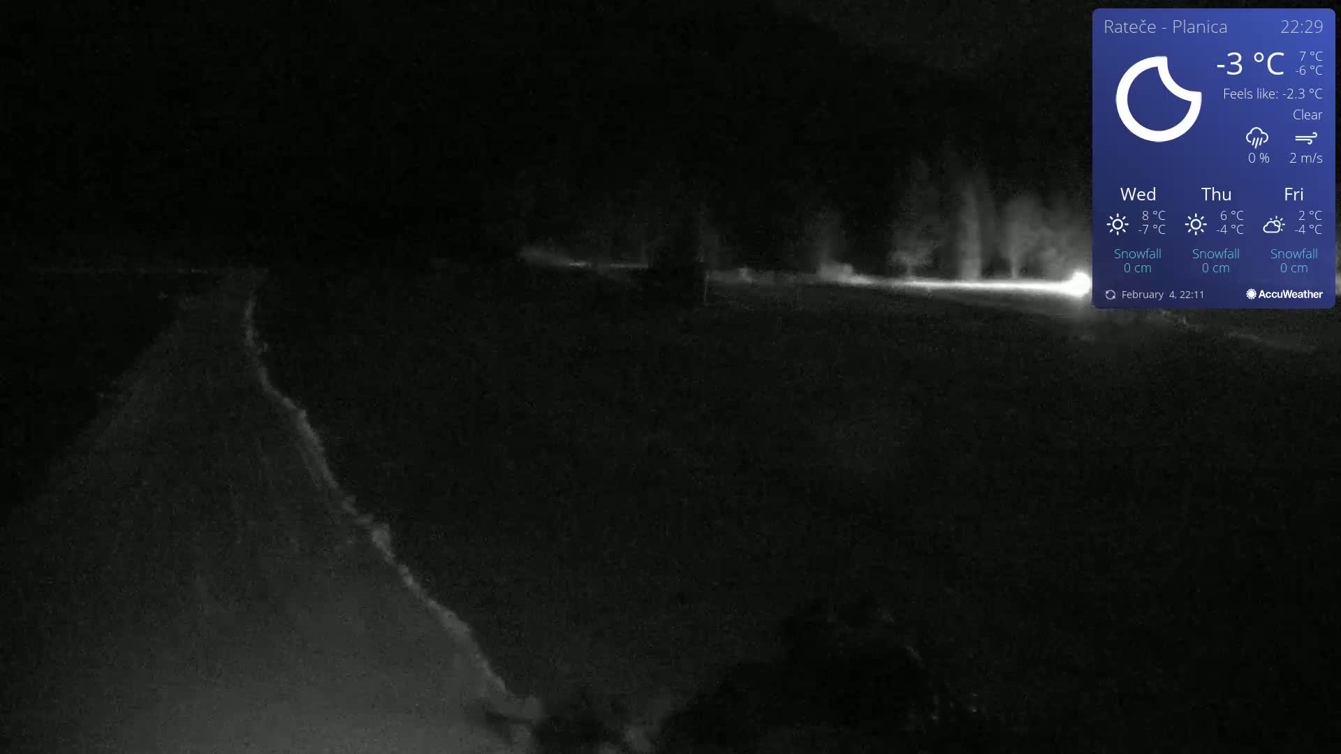A nighttime, clear, outdoor scene shows a dimly lit road with faint light sources in the distance under a -3°C temperature.