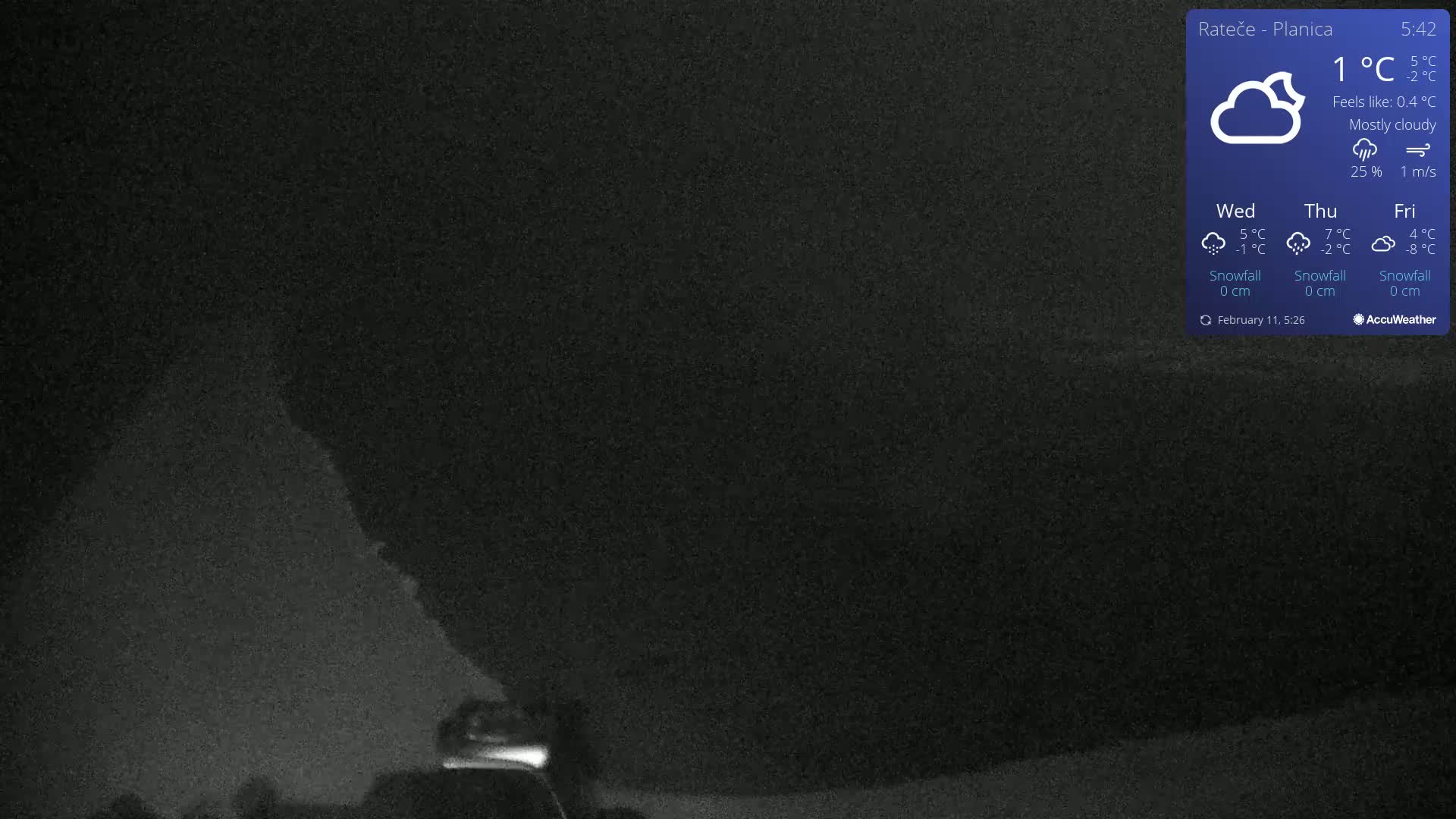 A mostly cloudy night scene shows a dark hill or mountain under a dark sky with a low light source near the bottom.