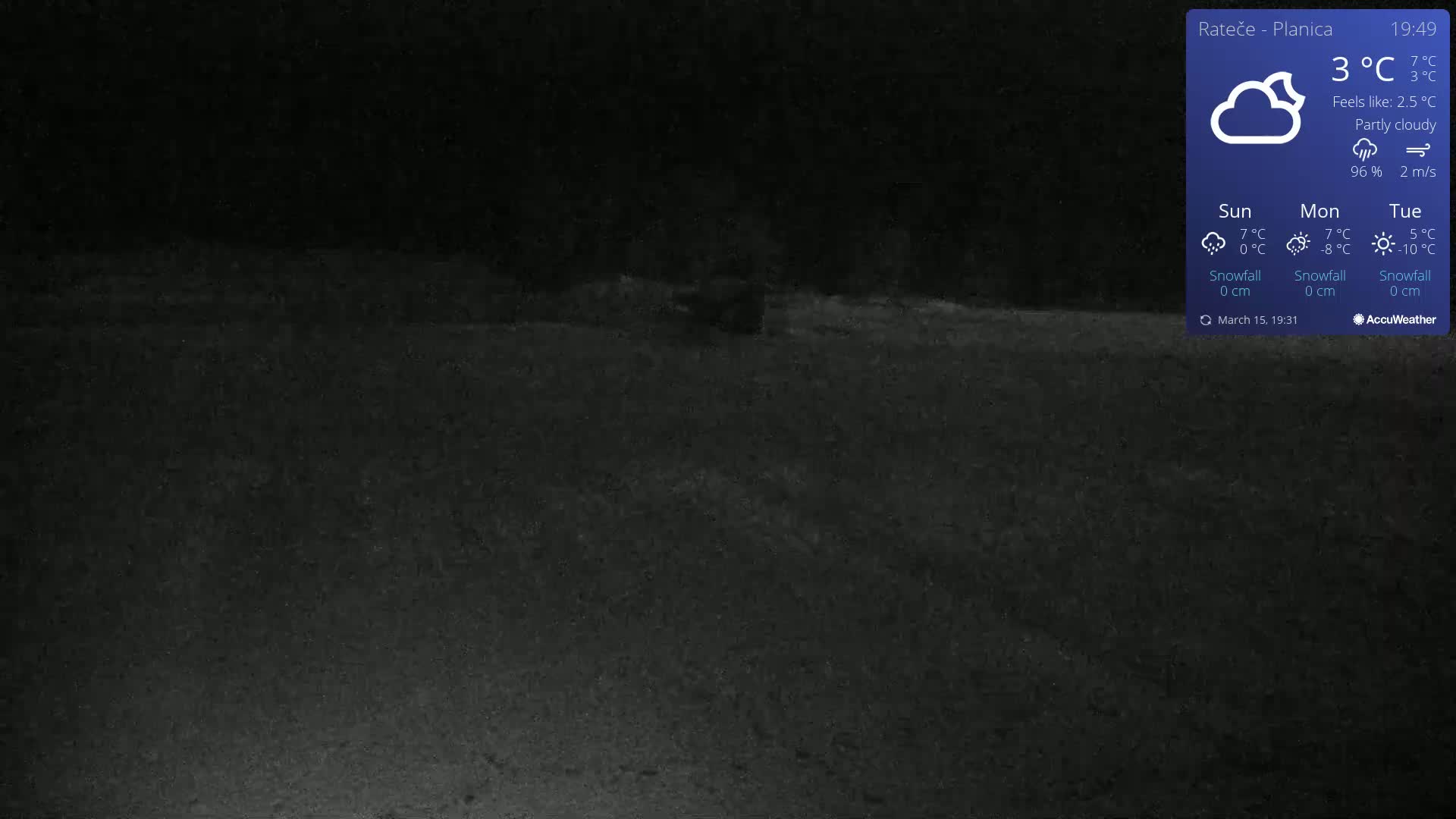 A dark, nighttime outdoor scene shows a mostly flat, empty area under partly cloudy skies.