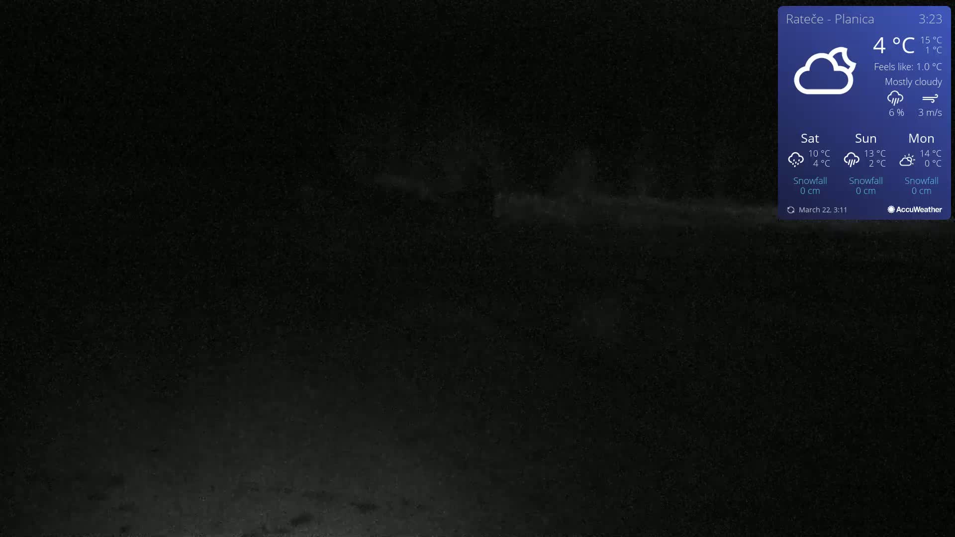 A mostly cloudy night scene with a light source in the distance.