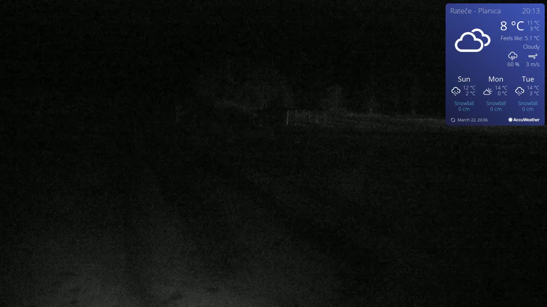A dark, nighttime outdoor scene under cloudy conditions shows a mostly indistinct, flat area.