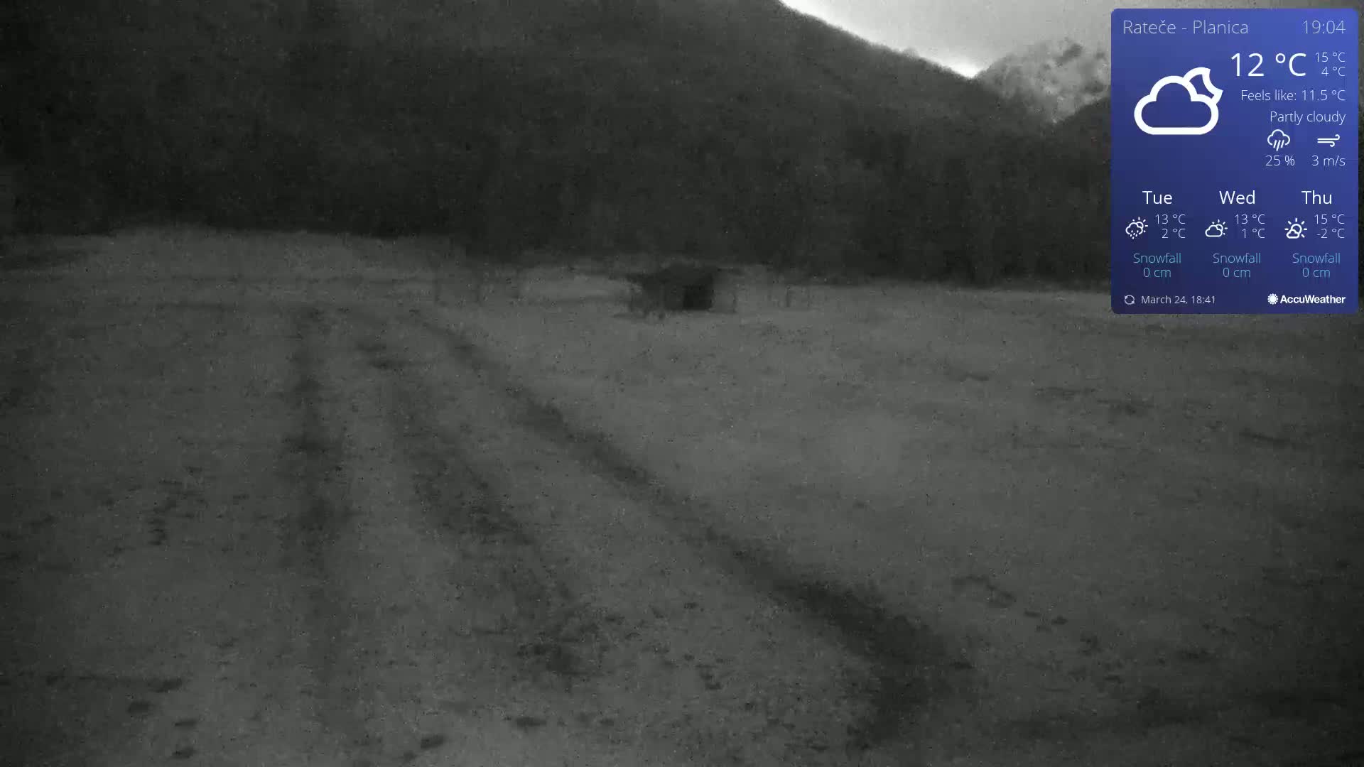 A dark, partly cloudy outdoor scene shows a dirt road leading towards a small structure, with a hill visible in the background.
