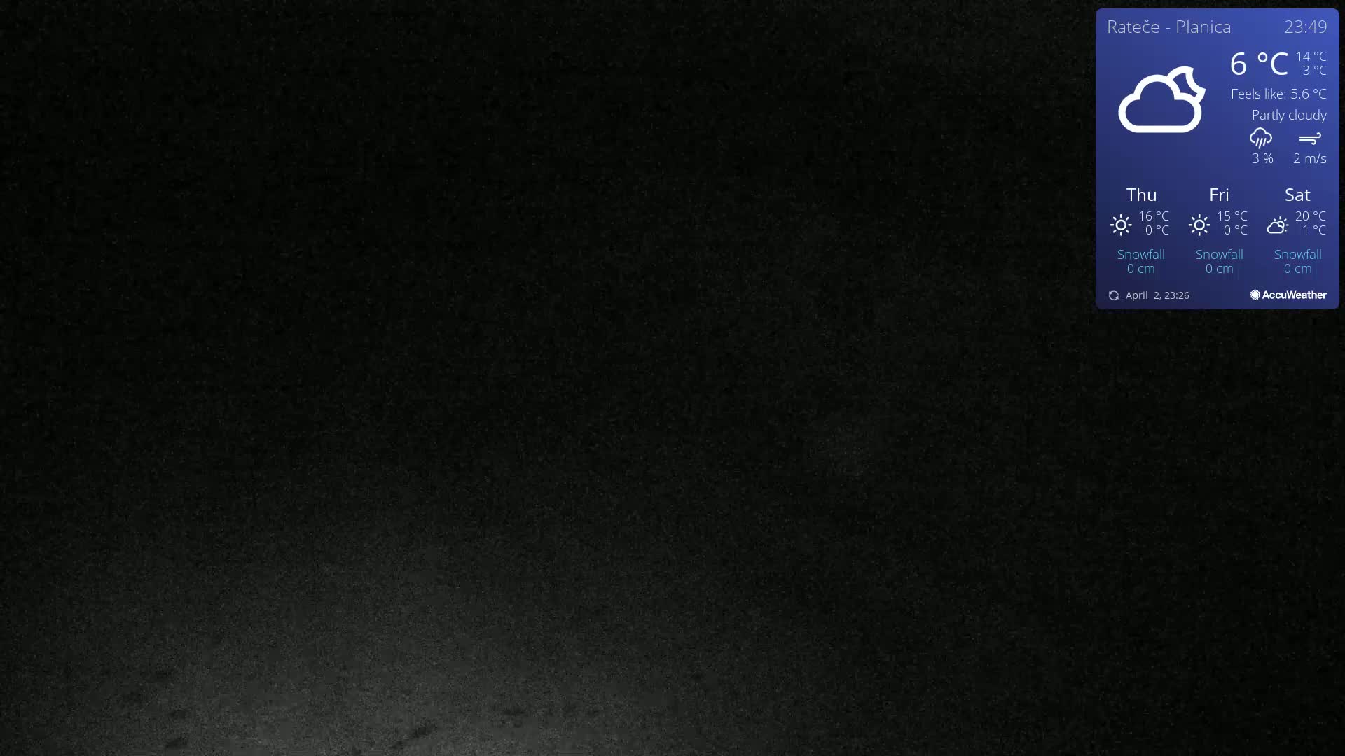 A dark, mostly black image shows a partly cloudy night sky.