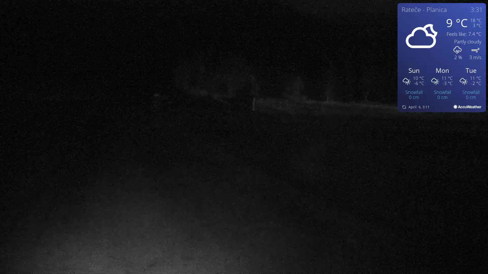A dark, nighttime image shows a dimly lit, empty road or path under partly cloudy skies.
