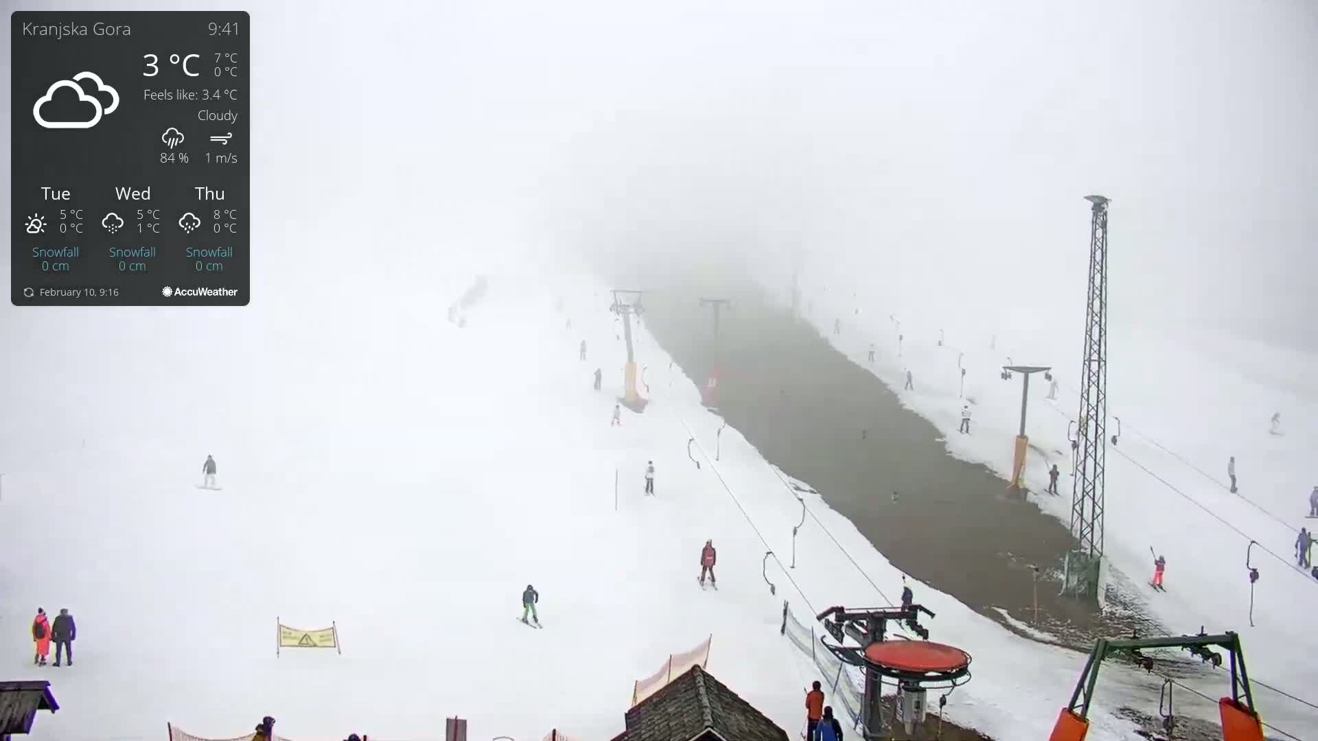 A snowy ski slope is visible in a thick fog, with several skiers and chairlifts scattered across the scene.