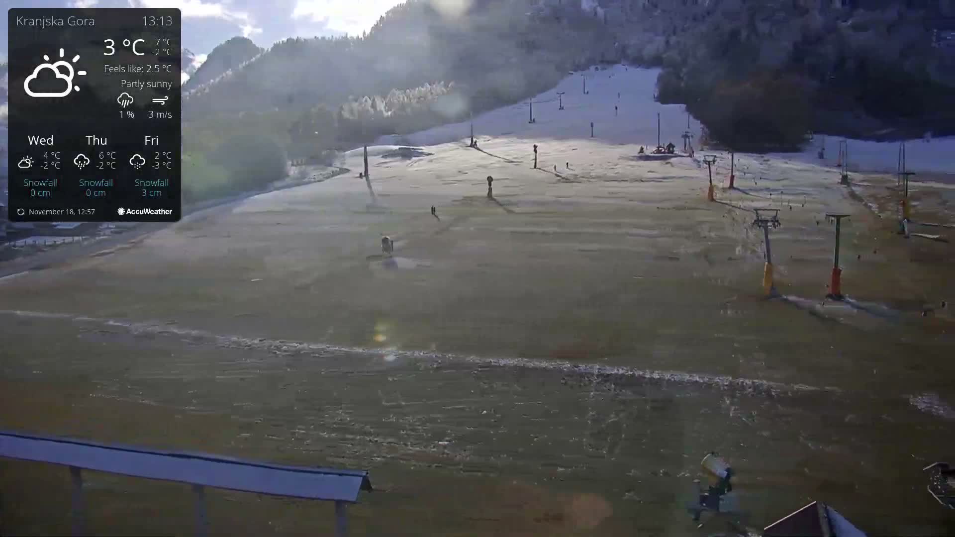 The image depicts a very dark outdoor scene at night with numerous faint, diffuse vertical streaks illuminated by a bright light source, suggestive of falling precipitation and low visibility.