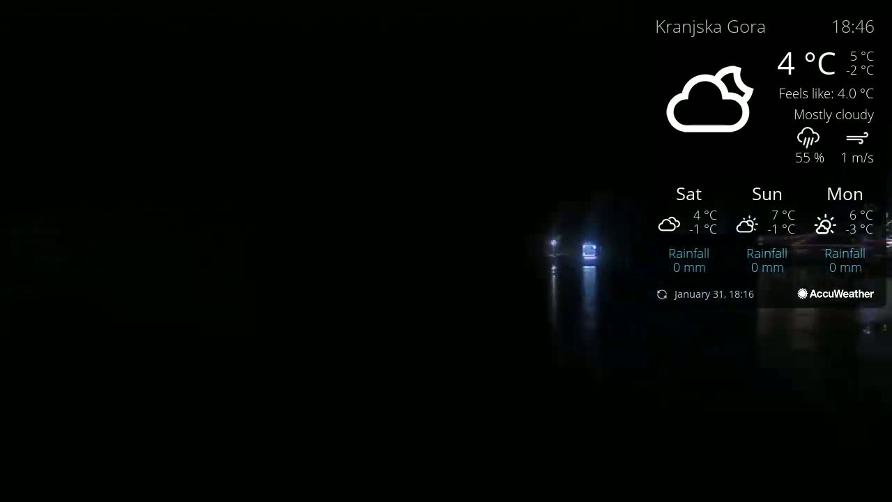 A mostly cloudy nighttime scene shows a dark body of water reflecting lights, with the temperature at 4°C.