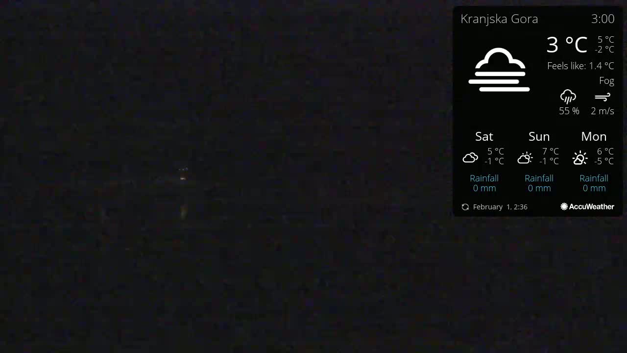 A dark, foggy nighttime scene is shown with a faint light source in the distance.