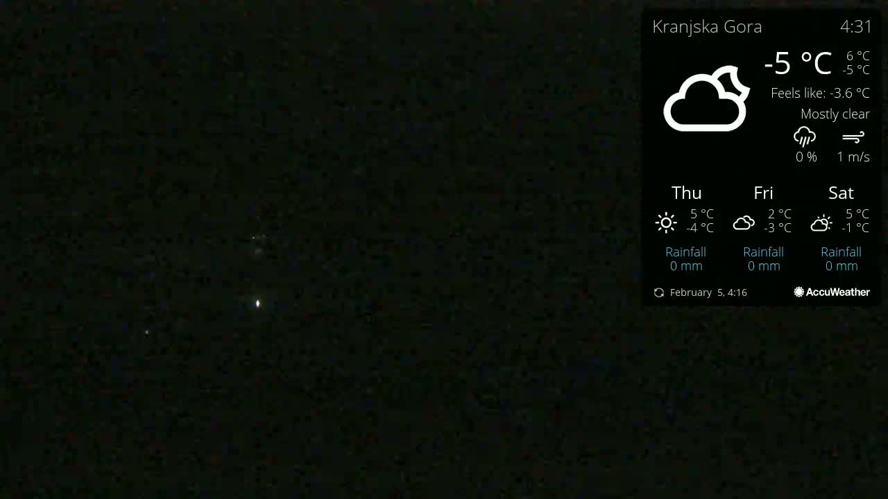 A mostly clear night sky with a few faint lights visible, under a -5°C temperature.