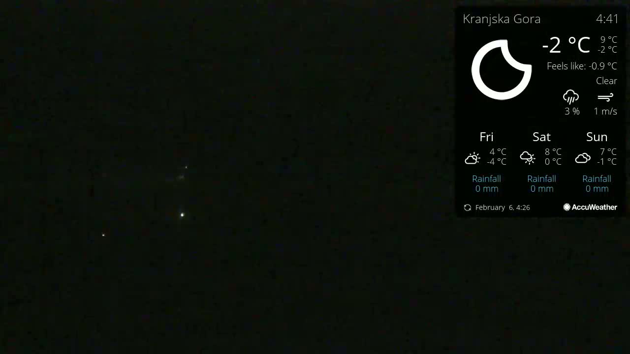 A dark, clear night sky shows a few distant lights.