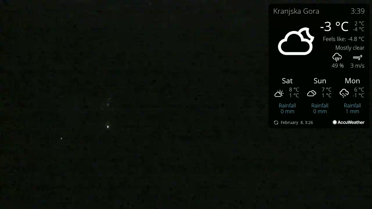 A mostly clear night sky with a few faint lights visible, under a temperature of -3°C.