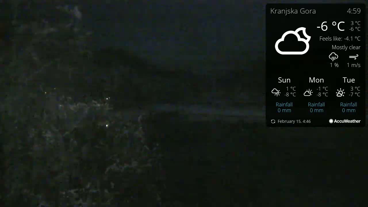 A dark, nighttime scene shows dark water with small waves under a mostly clear sky.